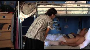 Marisa Tomei as Kate tries to wake up Ben so that her son, Joey, can have some privacy in his room. 